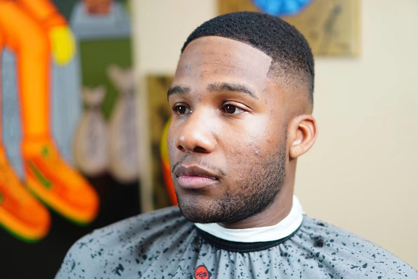 Close side view of a short taper with a crisp line-up along the forehead.