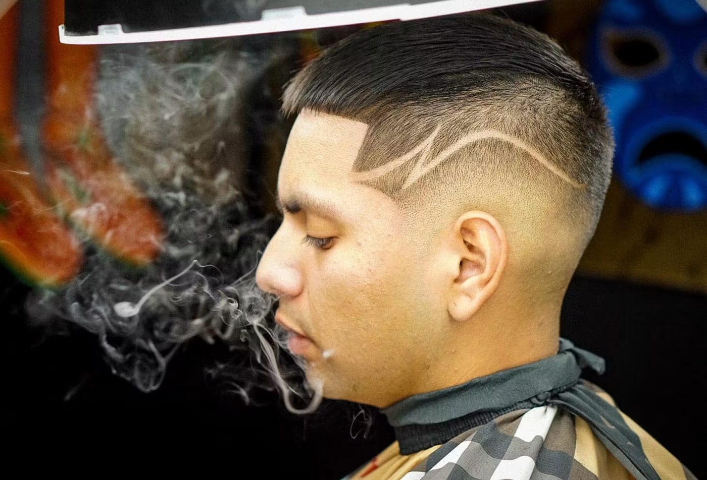 Mid fade with a freestyle razor design carved through the side.